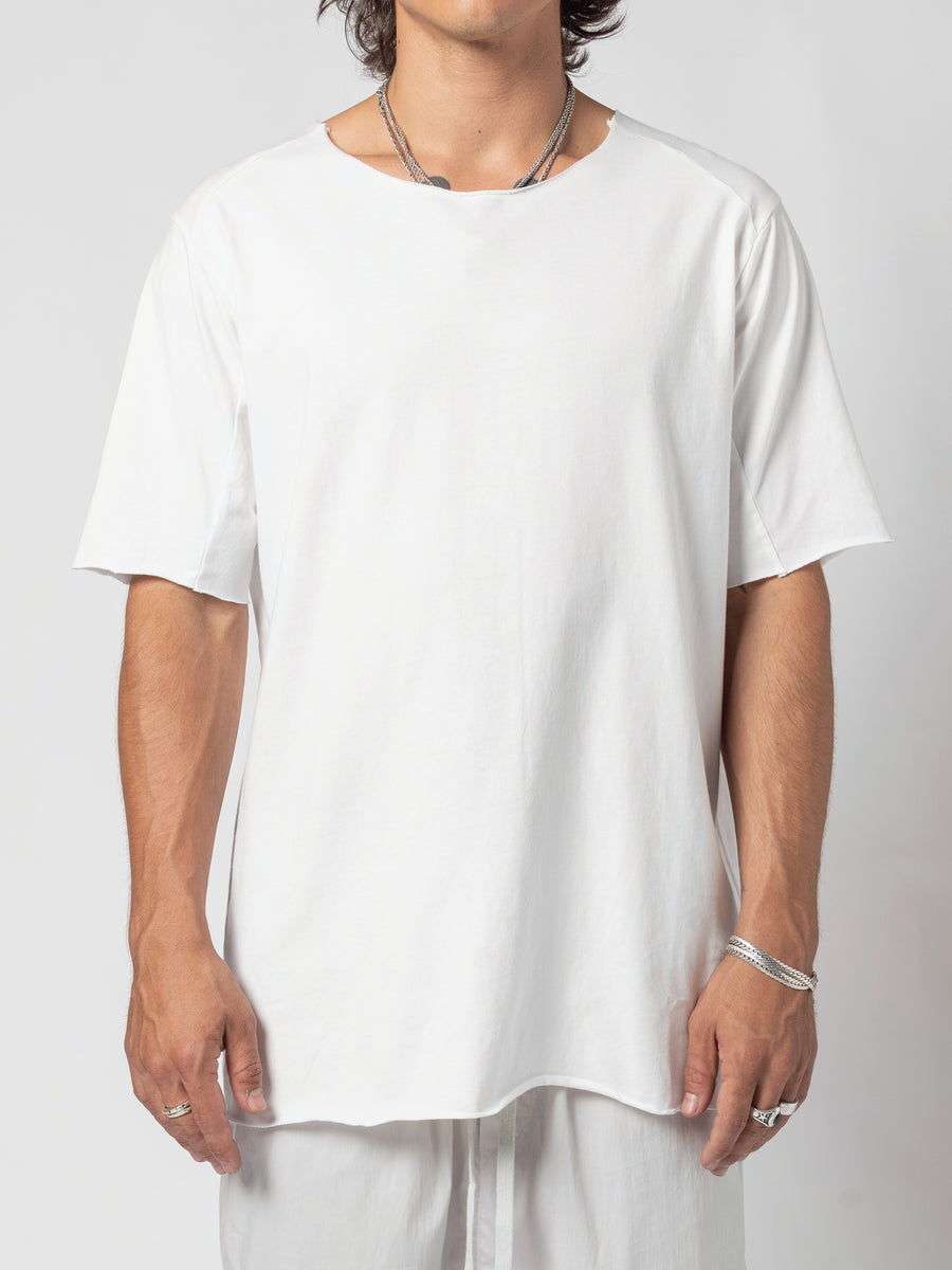 AITO Scar Stitch Cotton T-Shirt in White — front view of the torso, arms resting at the sides and the curved hem falling below the hip
