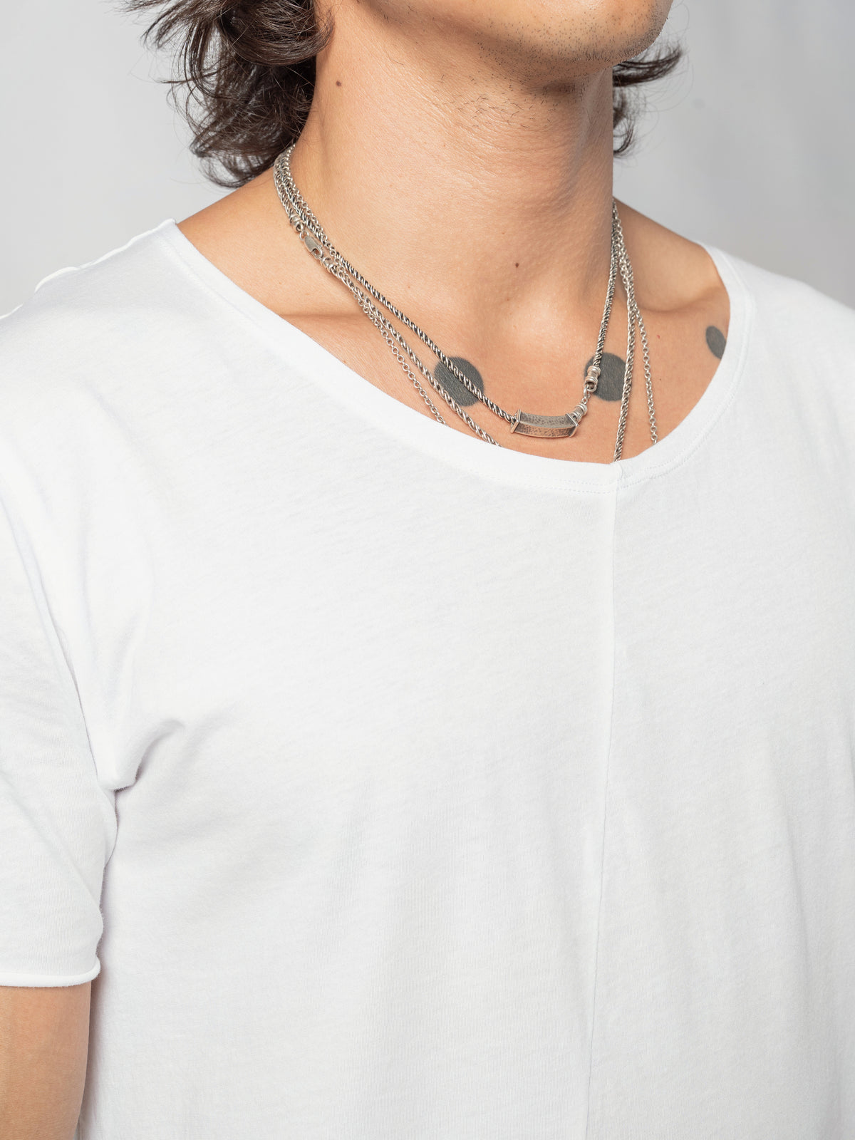 AITO Scoop Neck Cotton T-Shirt in White — close-up of the scoop neckline and upper chest, the centre-front seam running down from it