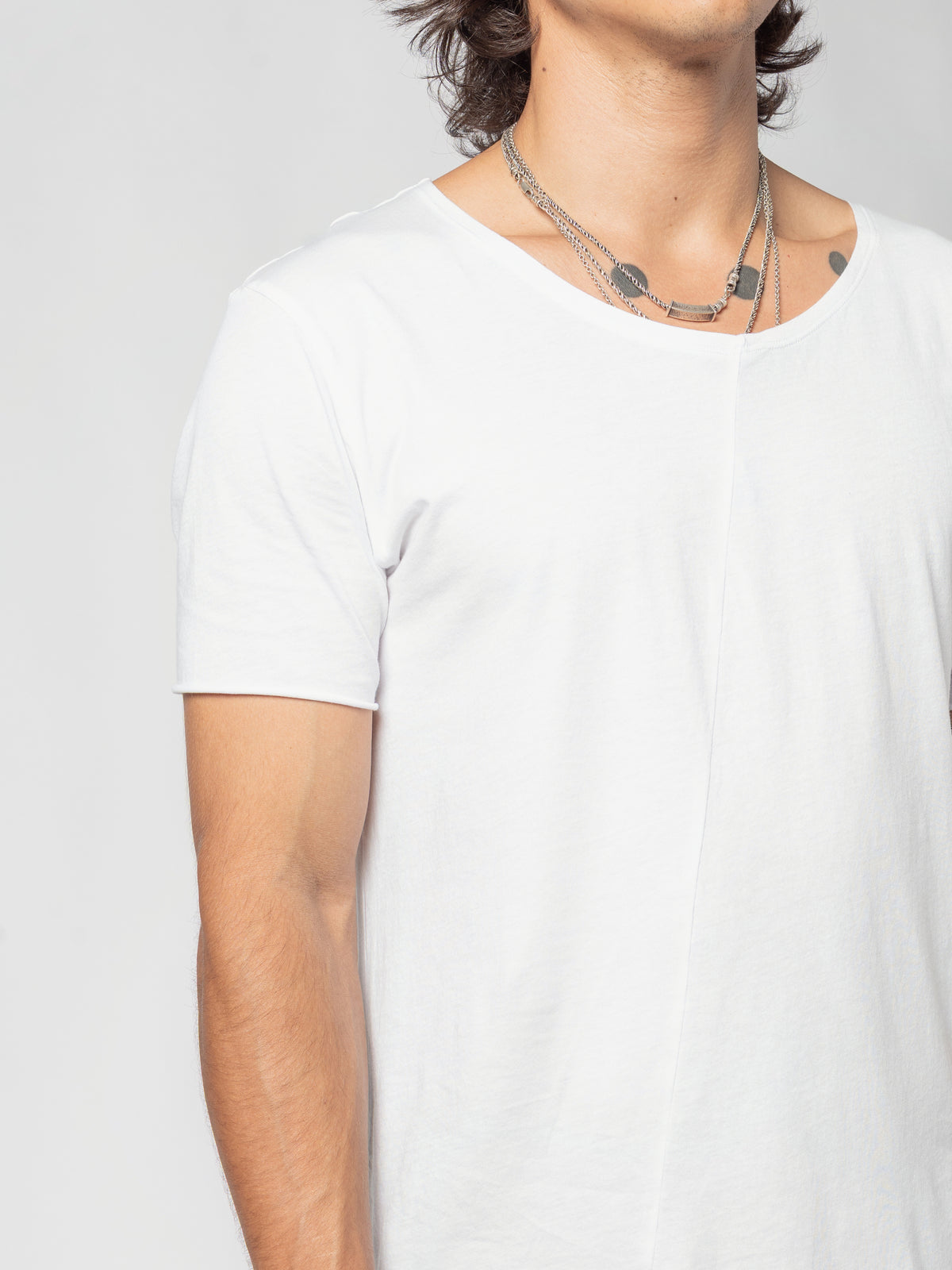 AITO Scoop Neck Cotton T-Shirt in White — upper body from the front, head turned to one side, one short sleeve nearest the camera