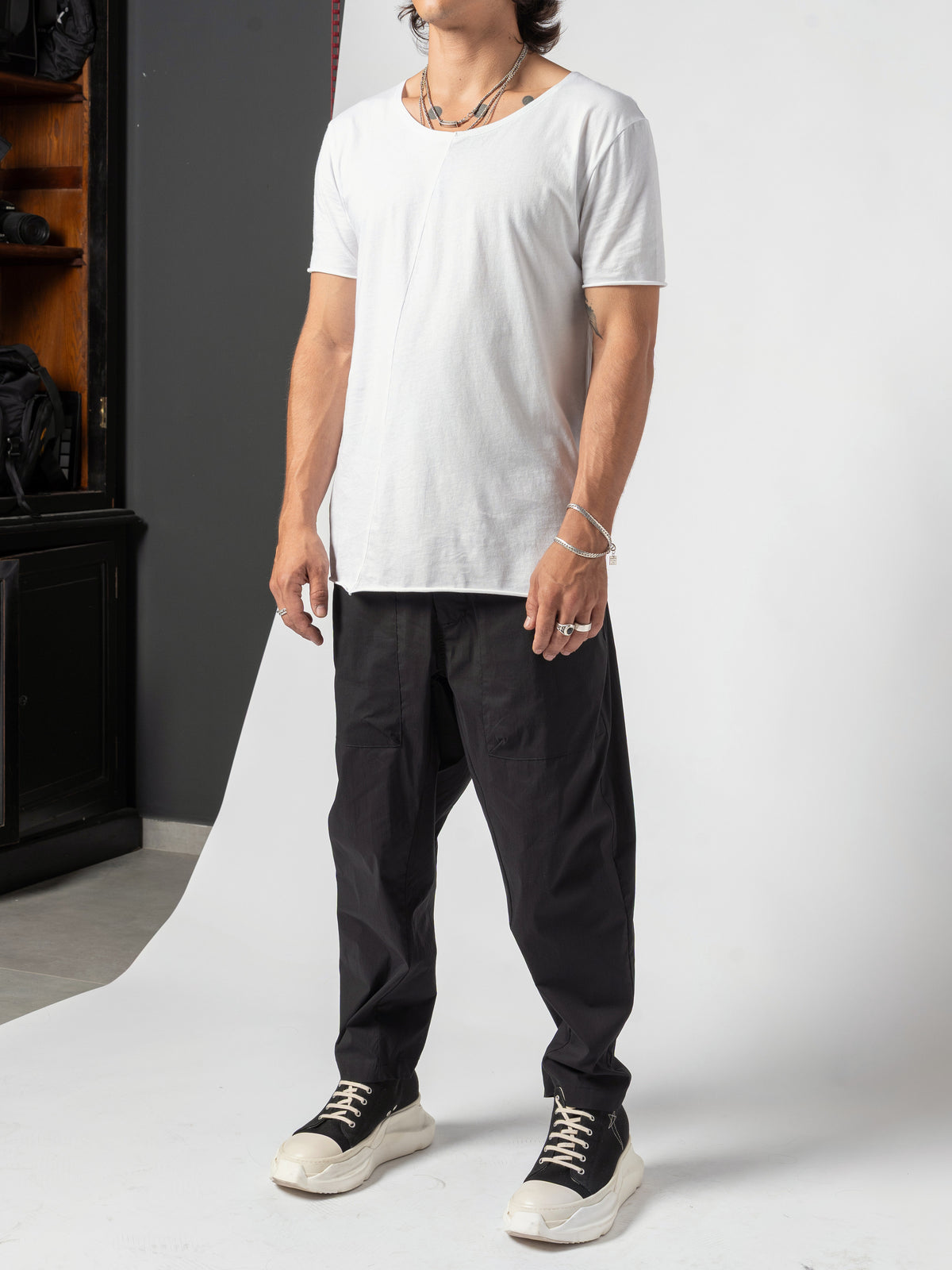 AITO Scoop Neck Cotton T-Shirt in White — full-length front on the white sweep, the whole outfit in frame down to the trainers