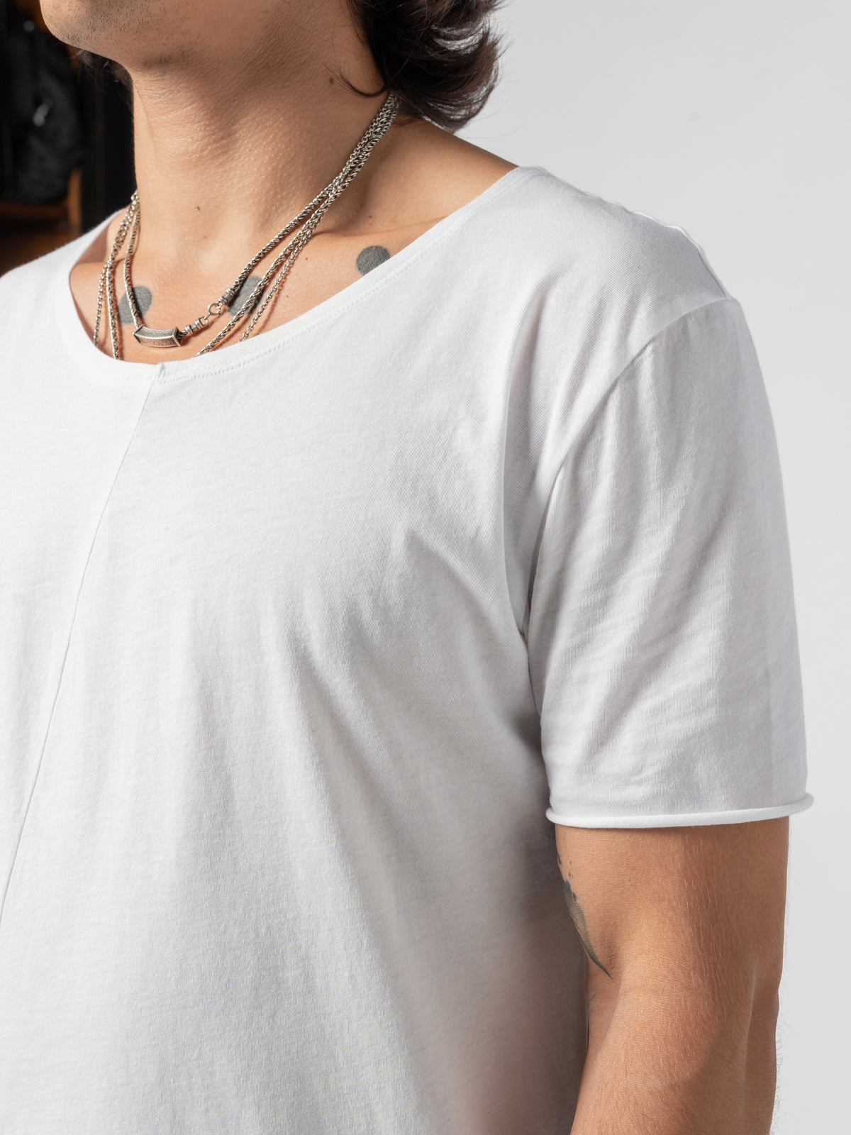 AITO Scoop Neck Cotton T-Shirt in White — close-up of one shoulder and short sleeve, the neckline crossing the top of the frame