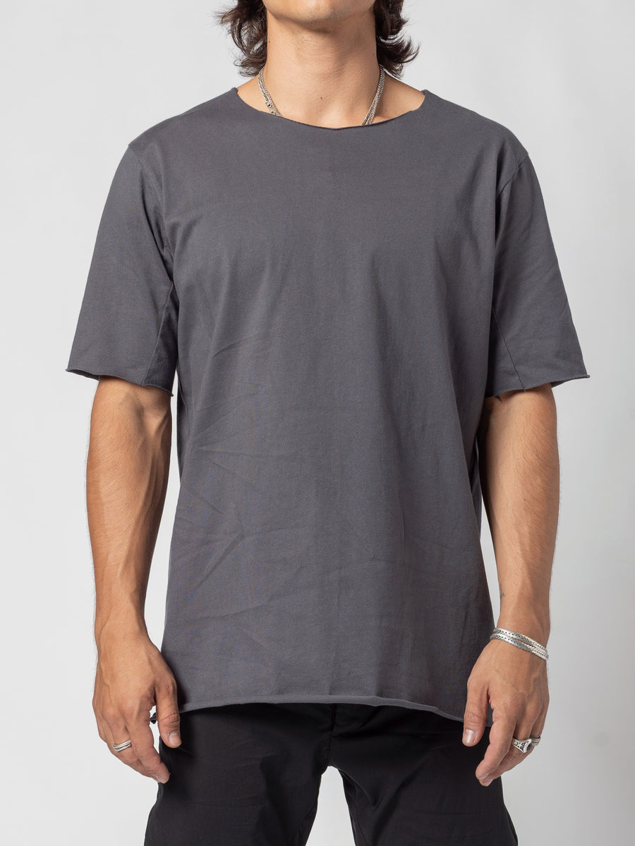 AITO Scar Stitch Cotton T-Shirt in Charcoal — front view from chin to hip, arms hanging loose, the curved hem falling over black trousers
