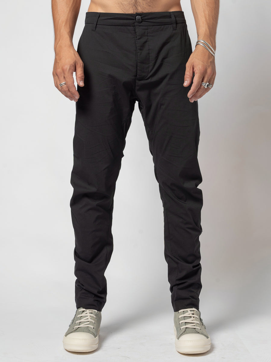 AITO Low-Rise Slim Pants in Black — front view, full length, worn with trainers and both hands at the sides