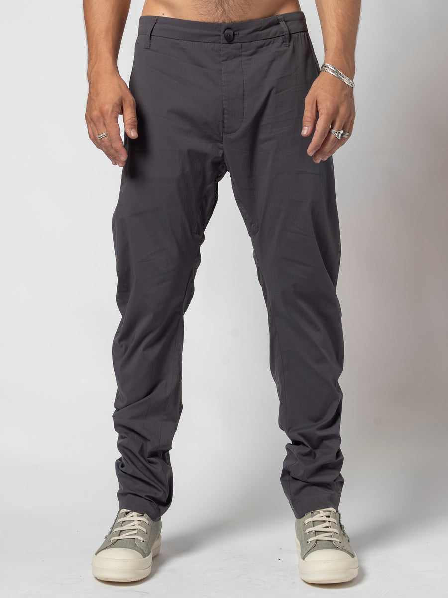 AITO Low-Rise Slim Pants in Dark Grey — front view from the waist down, model square to the camera with both feet flat and the hems breaking on the trainers