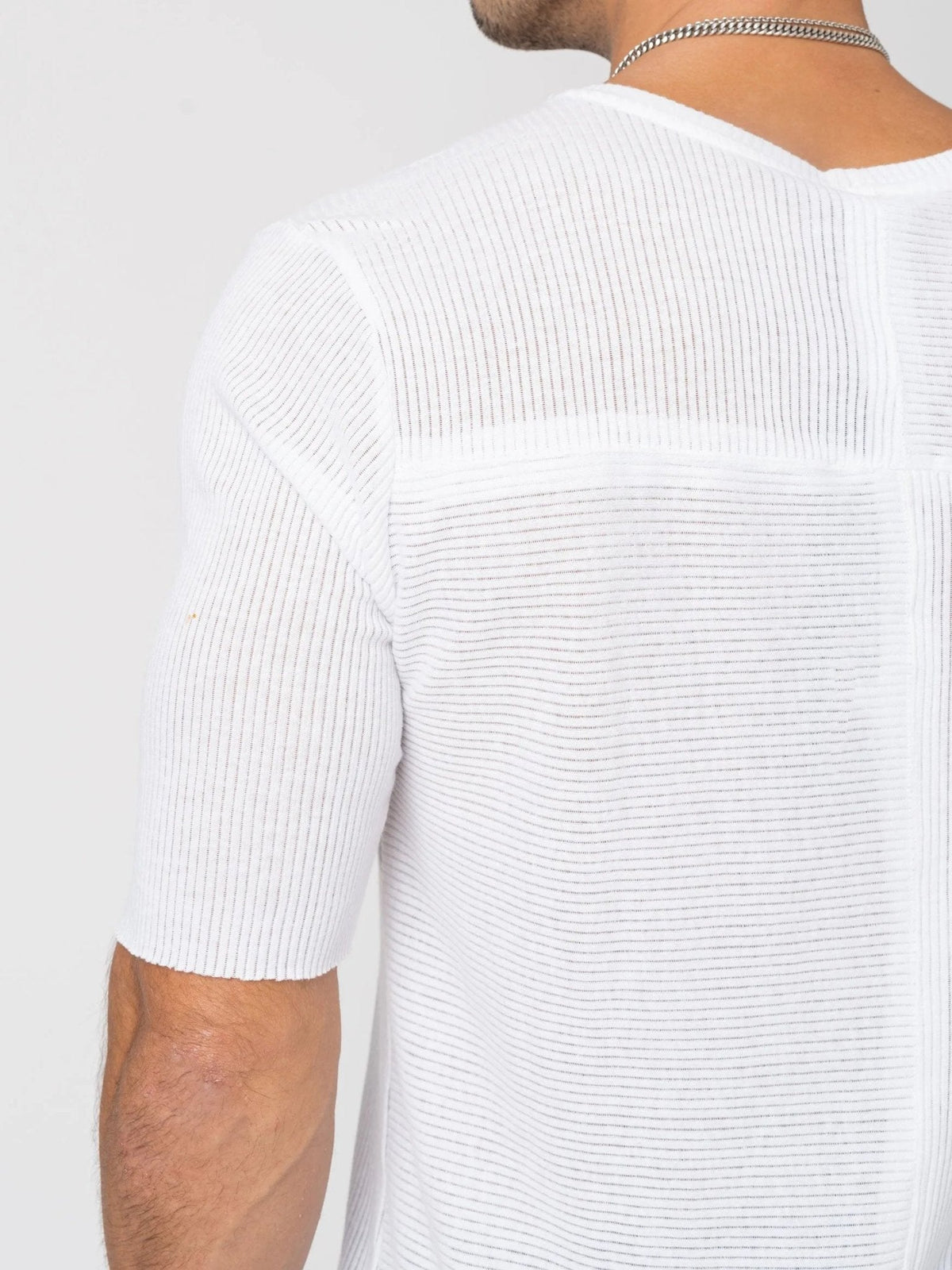 AITO Ribbed Cotton T-Shirt in White — close-up of the back yoke and directional rib panels