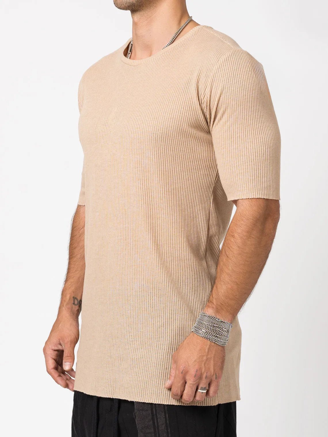 AITO Ribbed Cotton T-Shirt in Beige — three-quarter view showing the slim fit and elongated below-hip body