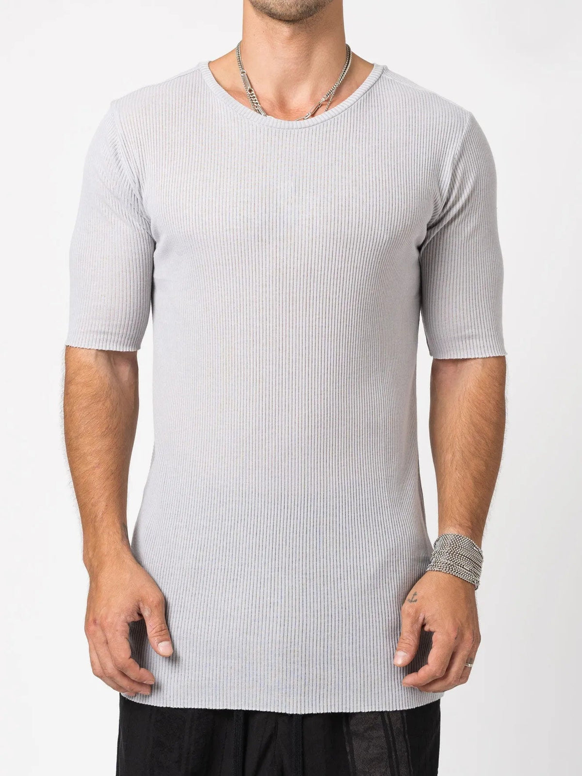 AITO Ribbed Cotton T-Shirt in Light Grey — front view on model, showing the raw rolled crew neck and slim, elongated body.