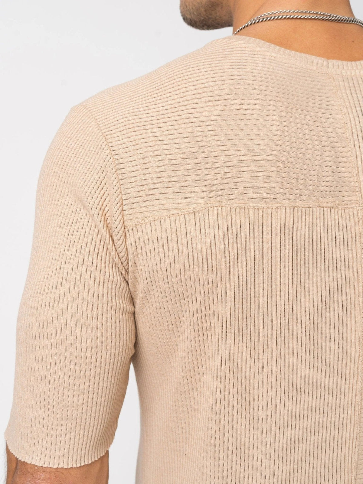 AITO Ribbed Cotton T-Shirt in Beige — close-up of the horizontal-ribbed yoke meeting the centre-back seam