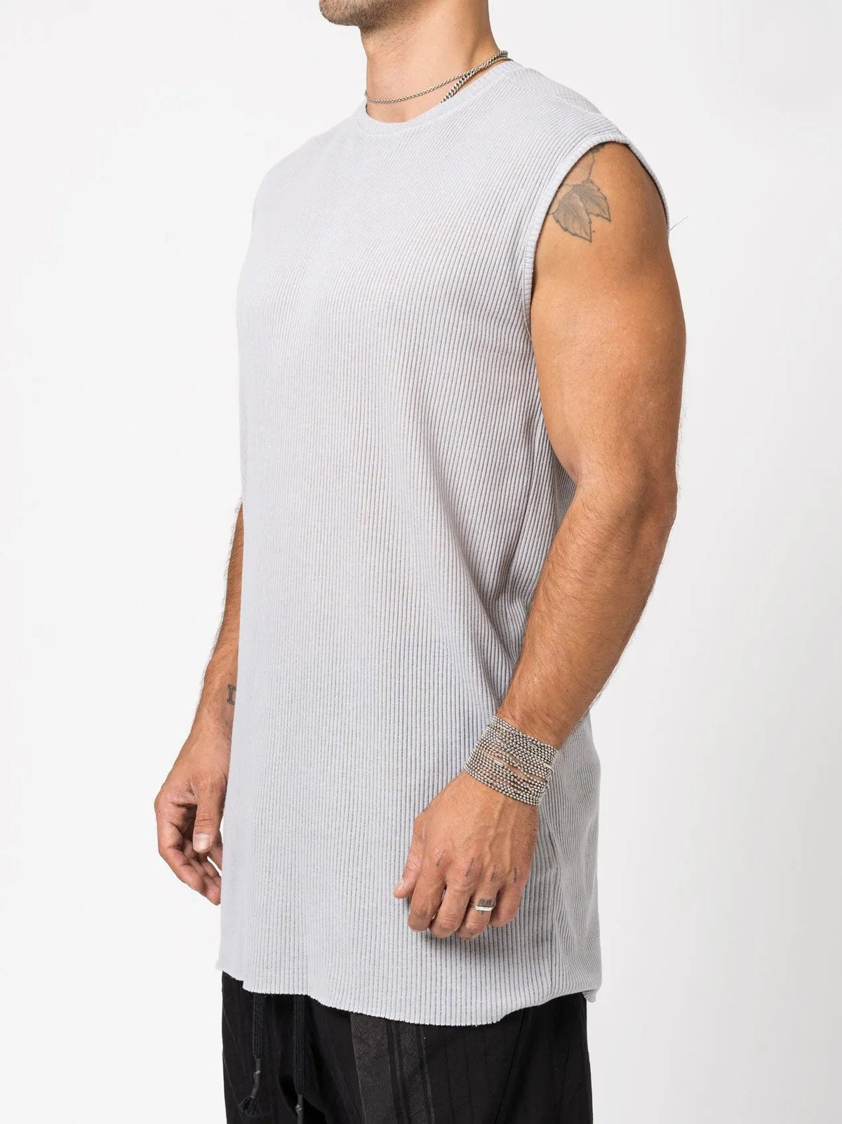 AITO Ribbed Tank Top in Light Grey — three-quarter view on model showing the longline side and softly curved hem