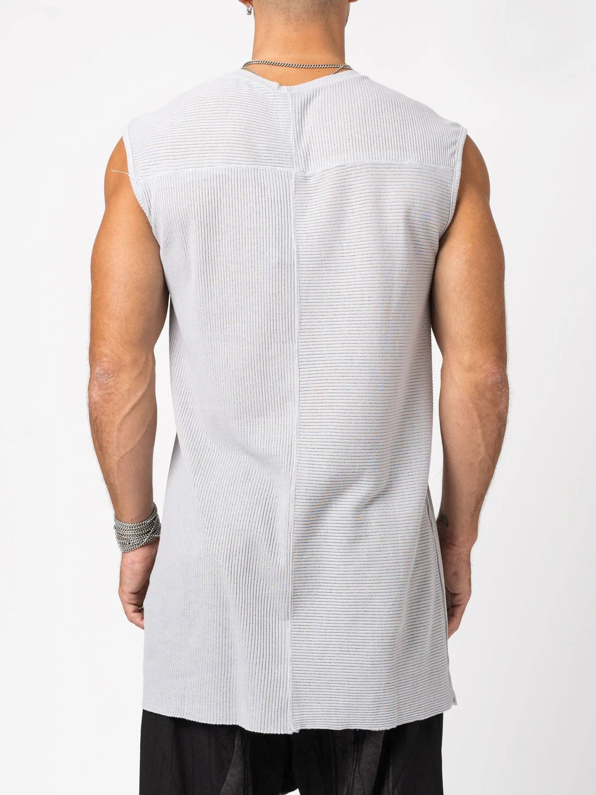 AITO Ribbed Tank Top in Light Grey — back view on model showing the ribbed yoke and raw centre-back seam splitting two rib-direction panels