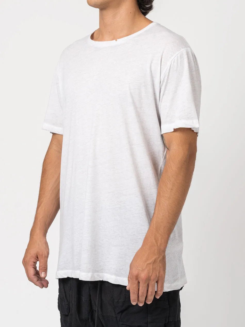 AITO Vintage Washed Cotton T-Shirt in Stone — three-quarter front view on model, showing the relaxed drape and raw-edge sleeve cuffs