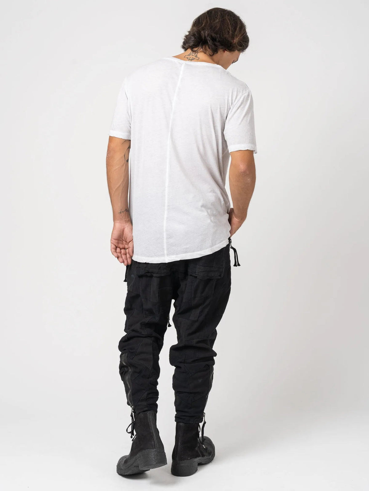 AITO Vintage Washed Cotton T-Shirt in Stone — full-length back view on model, showing the centre-back seam and raw rolled hem