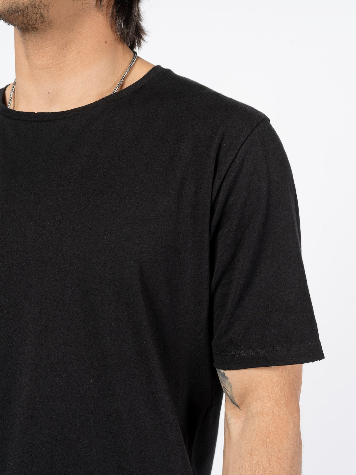 AITO Washed Cotton T-Shirt in Black — garment detail of the washed cotton jersey surface and finish