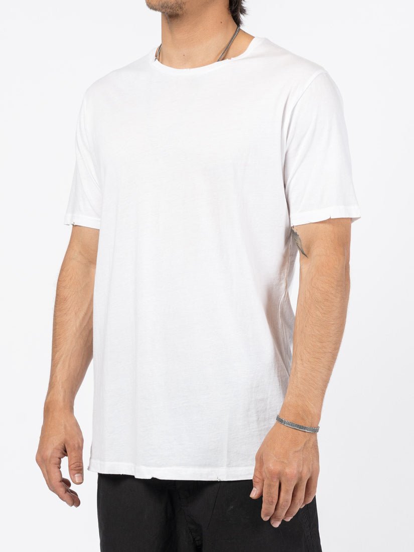 AITO Washed Cotton T-Shirt in White — three-quarter side view on model showing the soft drape and raw sleeve hem