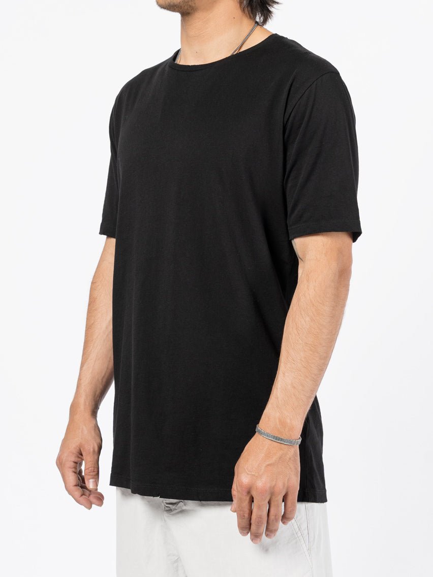 AITO Washed Cotton T-Shirt in Black — three-quarter side view on model, showing the drape and side profile