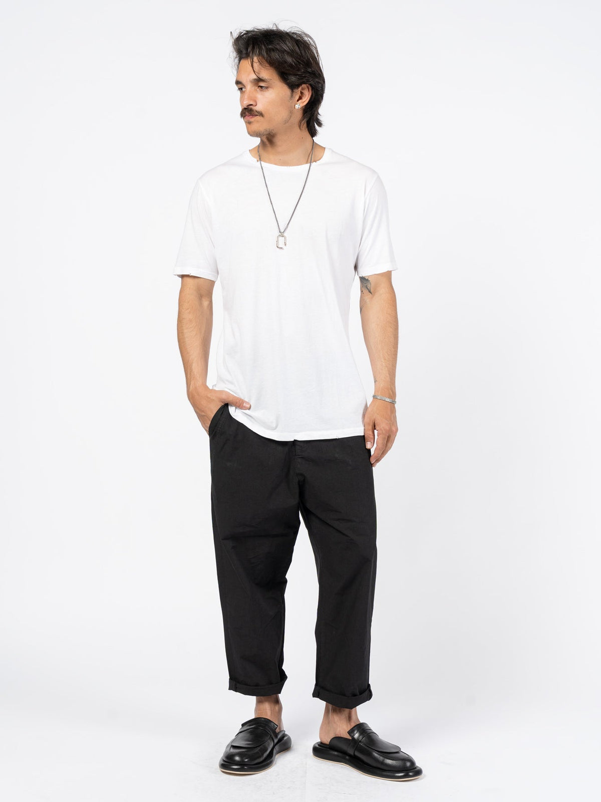 AITO Washed Cotton T-Shirt in White — full-length front view on model, relaxed hip-length cut worn with black trousers